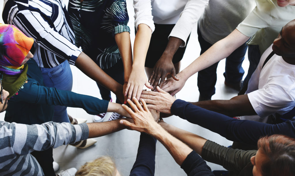 Diversity teamwork with joined hands